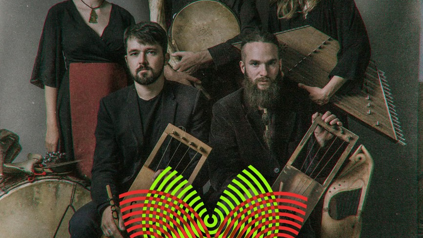 Two women and three men, all holding antique-looking instruments, wearing simple black clothes, one of the women wearing a fancy headband.