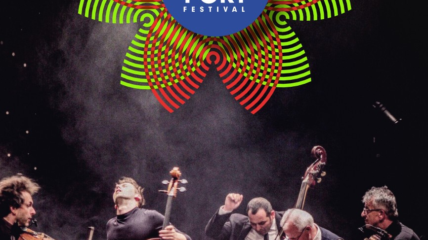 Five instrumentalists during a concert, captured during engaged playing.