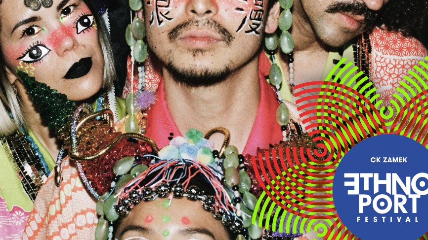 Four people with Asian features, the women have a second pair of eyes drawn on their cheeks, the men have Chinese characters. They are dressed in colorful clothes, have beads and fringes in their hair.