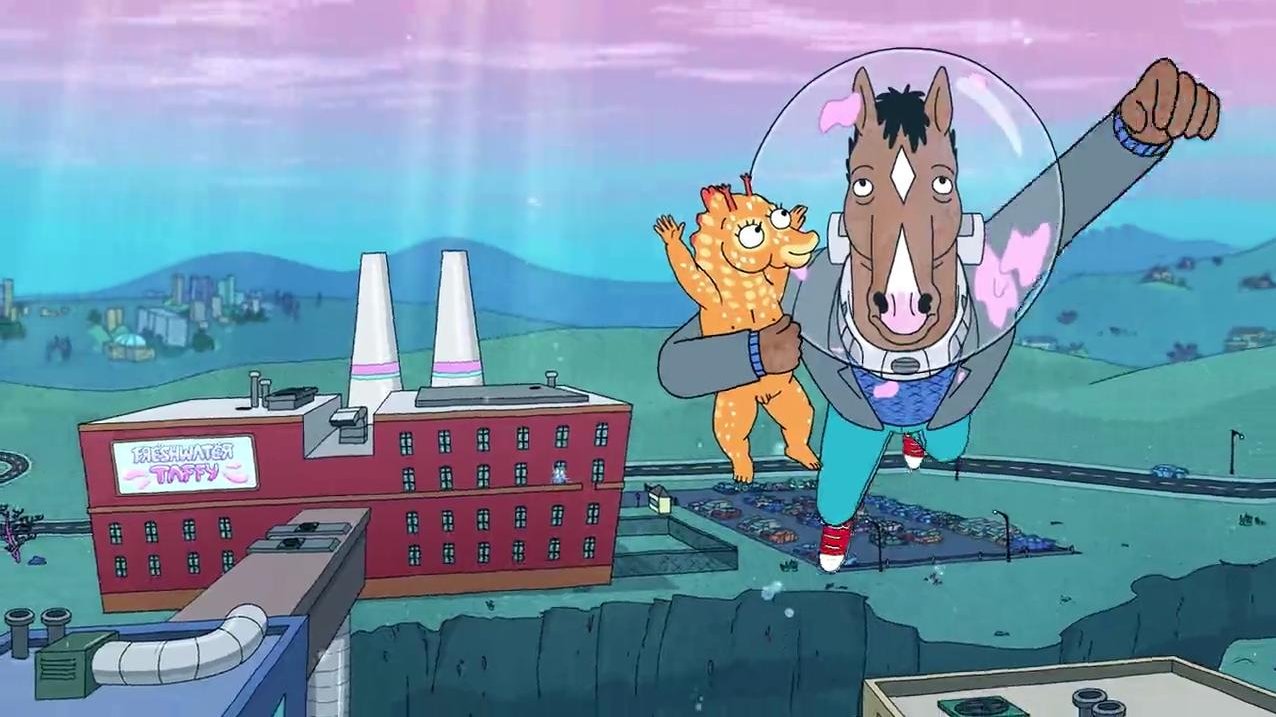 A frame from an animated film: two fantasy figures flying over a building and a field.