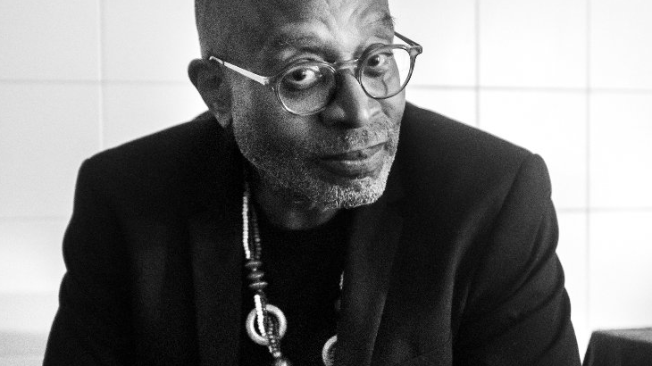 Black and white photo of Brian Jackson, who sits and looks into the camera.