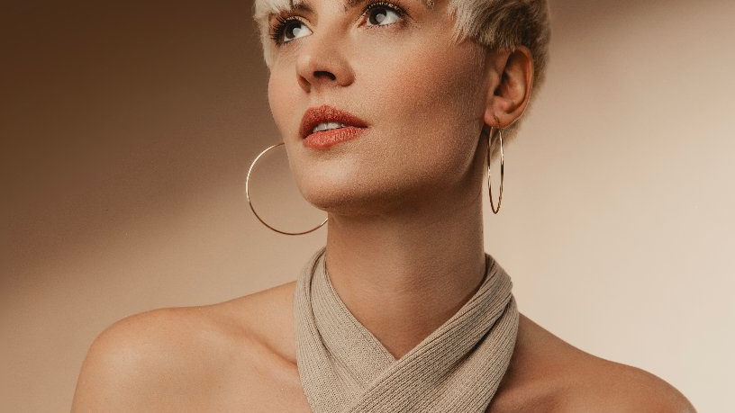 Photo of Mica Millar - a blond woman looking up.