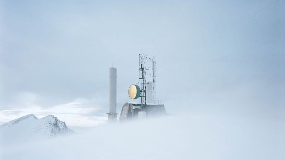 An object with a large, round lamp in a snowy, foggy wasteland.