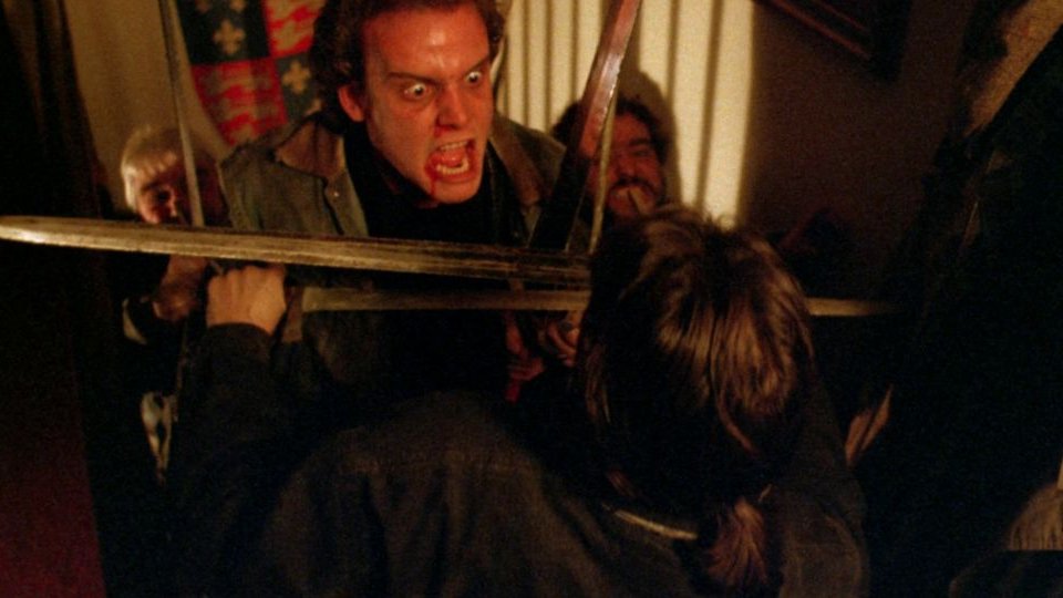 A man shouts at the person standing in front of him.