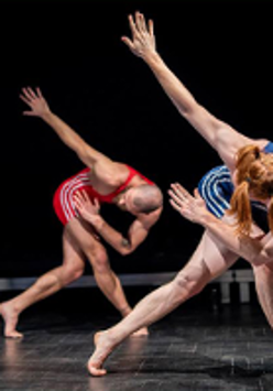 Two dancers in sportswears in similar poses.