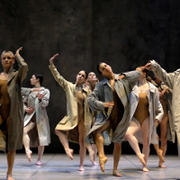 Photo from Fabula Rasa performance - dancers in coats performing on stage