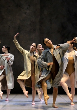 Photo from Fabula Rasa performance - dancers in coats performing on stage