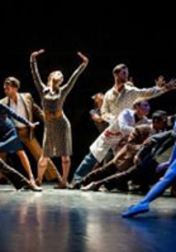 Photo from the performance - dancers in various poses on stage.
