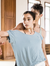 Two dancers - a woman and a man - in a dance pose.