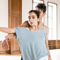 Two dancers - a woman and a man - in a dance pose.