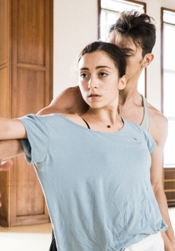 Two dancers - a woman and a man - in a dance pose.