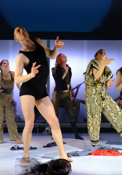 Photo from the performance: several people in various dance poses on stage.