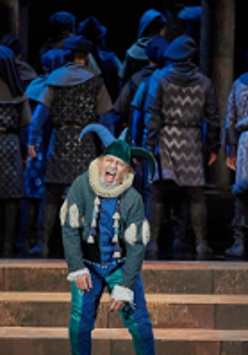 Photo from the performance: a man in a clown's disguise on stage