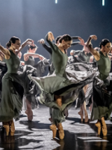 Photo from the performance: dancers in dance poses on stage.