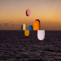 Picture of coloured pills which emerge from the sea or are under the sea's surface