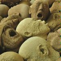 Photo of stone heads with open-mouthed faces