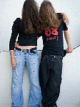 Picture of two people standing, with their long hair covering their faces