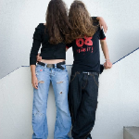 Picture of two people standing, with their long hair covering their faces