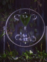 One of the works - a dark photo of an hourglass in a circle