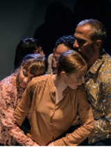 Photo of five people who are standing close to each other, but who do not look at each other