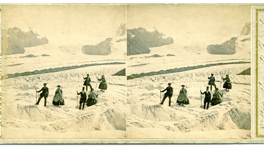 Stereoscopic photograph presenting three women in crinolines and three men in suits in the mountains covered with snow.