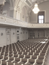 Black and white photo of rows of chairs in AMU Auditorium