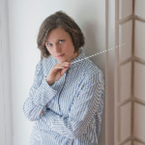 Photo of the Orchestra conductor - a woman holding a baton in her hand
