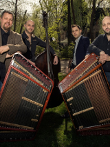 Photo of the band - four man standing by their musical instruments