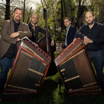 Photo of the band - four man standing by their musical instruments