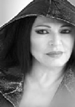 Black and white photo of the artist's face - a woman in a hood on her head.
