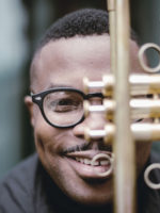 Face of the musician behind a trumpet