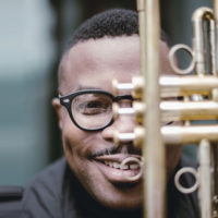 Face of the musician behind a trumpet