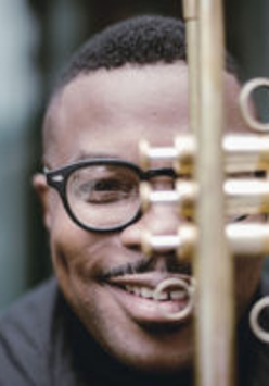 Face of the musician behind a trumpet