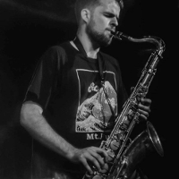 Black and white photo of a man playing the saxophone