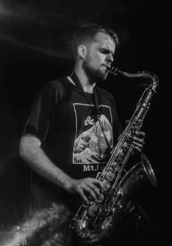 Black and white photo of a man playing the saxophone