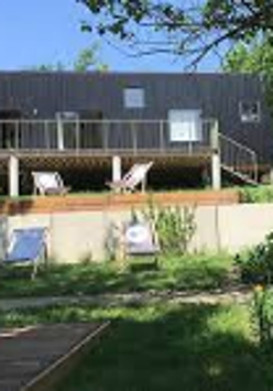 Picture of a building and the area in front of it with some deckchairs