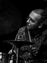 Black and white photo of the musician - a man playing drums