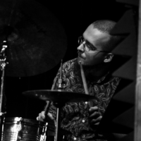 Black and white photo of the musician - a man playing drums