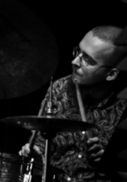 Black and white photo of the musician - a man playing drums