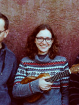 Photo of band members - one woman holding ukulele between two men