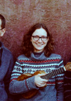 Photo of band members - one woman holding ukulele between two men