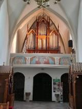 Photo of the church interior with pipe organ.