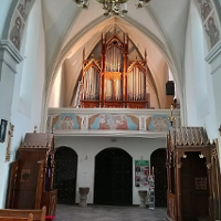 Photo of the church interior with pipe organ.