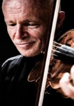 A photo of the artist - a man playing the violin