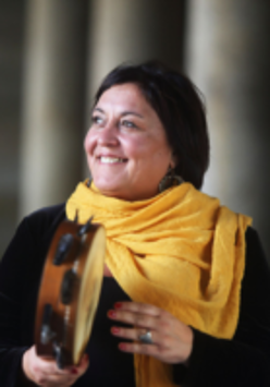 Photo of the artist - a smiling woman holding a musical instrument in her hands