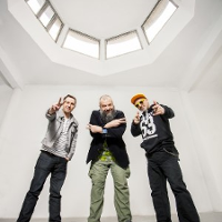 Members of the band - three man standing in white painted room