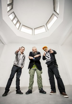 Members of the band - three man standing in white painted room