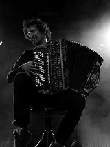 Black and white portrait of Yegor Zabelov, passionately playing the accordion.