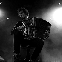 Black and white portrait of Yegor Zabelov, passionately playing the accordion.