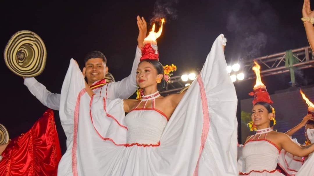 Photo of a group of performers from Colombia on stage in traditional folk costumes.